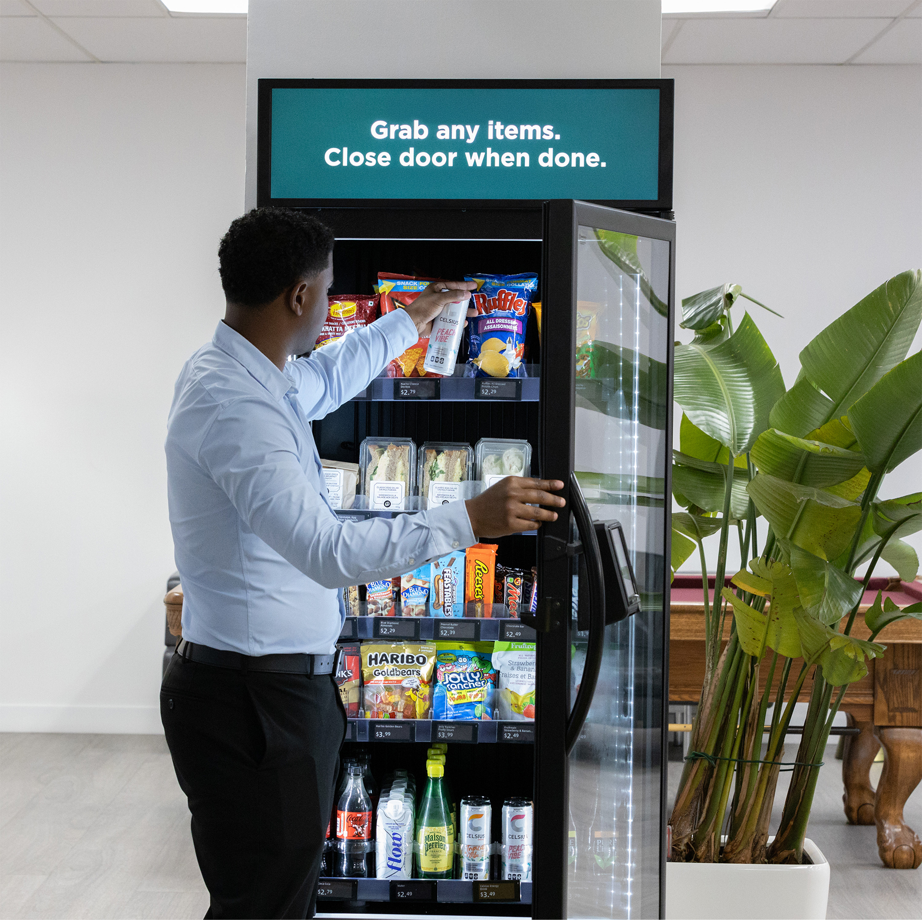 Person grabbing healthy snacks from smart vending machine