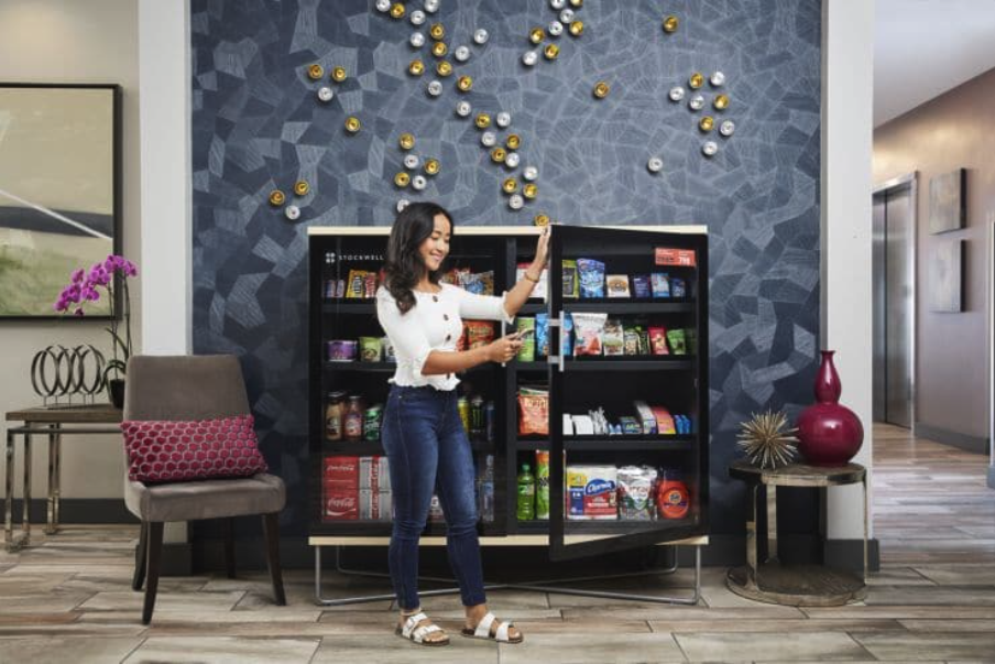 Smart Amenities team greeting a property manager in a modern lobby